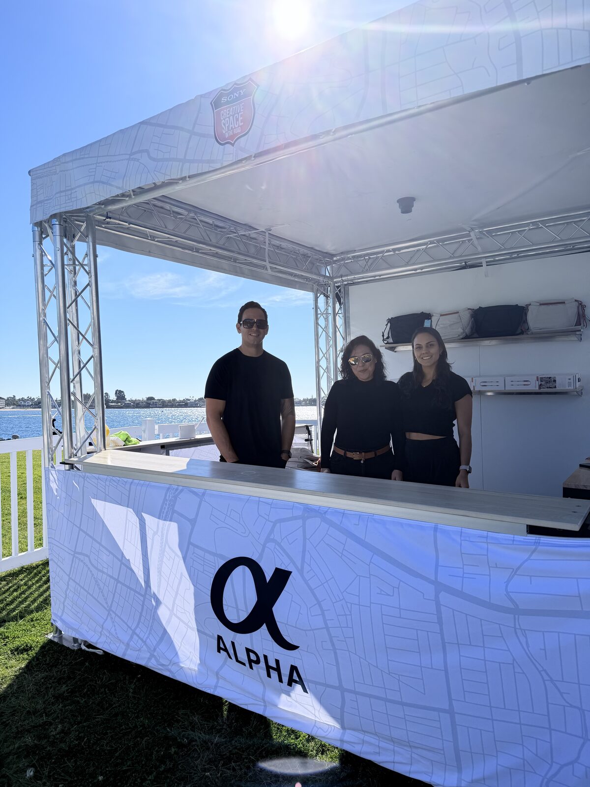 Outdoor branded activation booth with a live printing station
